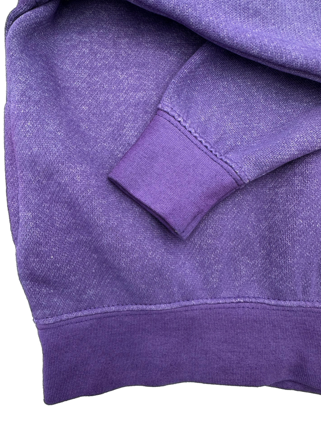 Closeup of solid dye example to illustrate 100% cotton cuff/hem and stitching vs 60/40 body