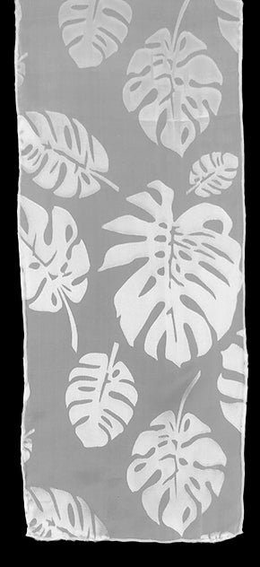 A sheer silk chiffon scarf with a rayon satin monstera leaf pattern, in white on a white background.