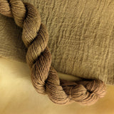 Onion Skins - Allium cepa L. Dyed examples were done at 50% OWG. We used our Silk Hankies (#SH), our Cotton Bubble Gauze (#CG2-50"), and our Single Sock HT Mini Skeins (#YARN104)