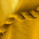 Turmeric - Curcuma longa Dyed examples were done at 50% OWG. We used our Silk Hankies (#SH), our Cotton Bubble Gauze (#CG2-50"), and our Single Sock HT Mini Skeins (#YARN104)