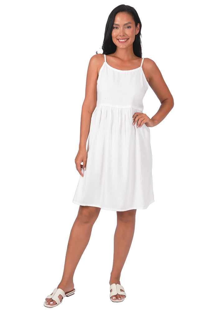 Woman wearing a white rayon knee-length dress with spaghetti straps on a white background.
