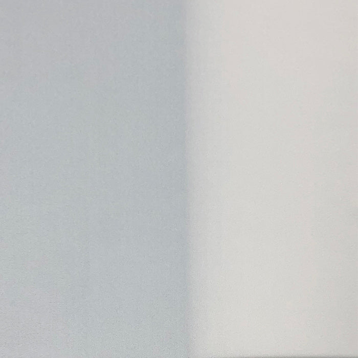 White fabric laid on top of both a black and a white backround, split down the center of image to show denier.