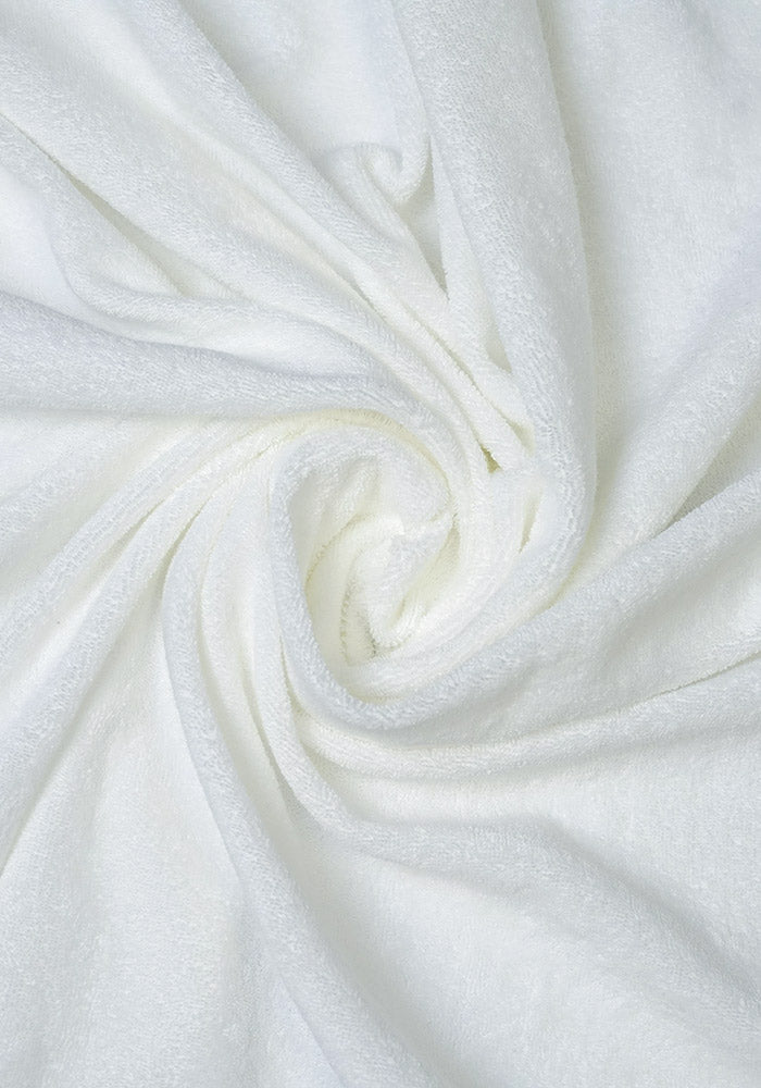 Close-up of twisted white fabric with a soft, low pile terry cloth loop texture.
