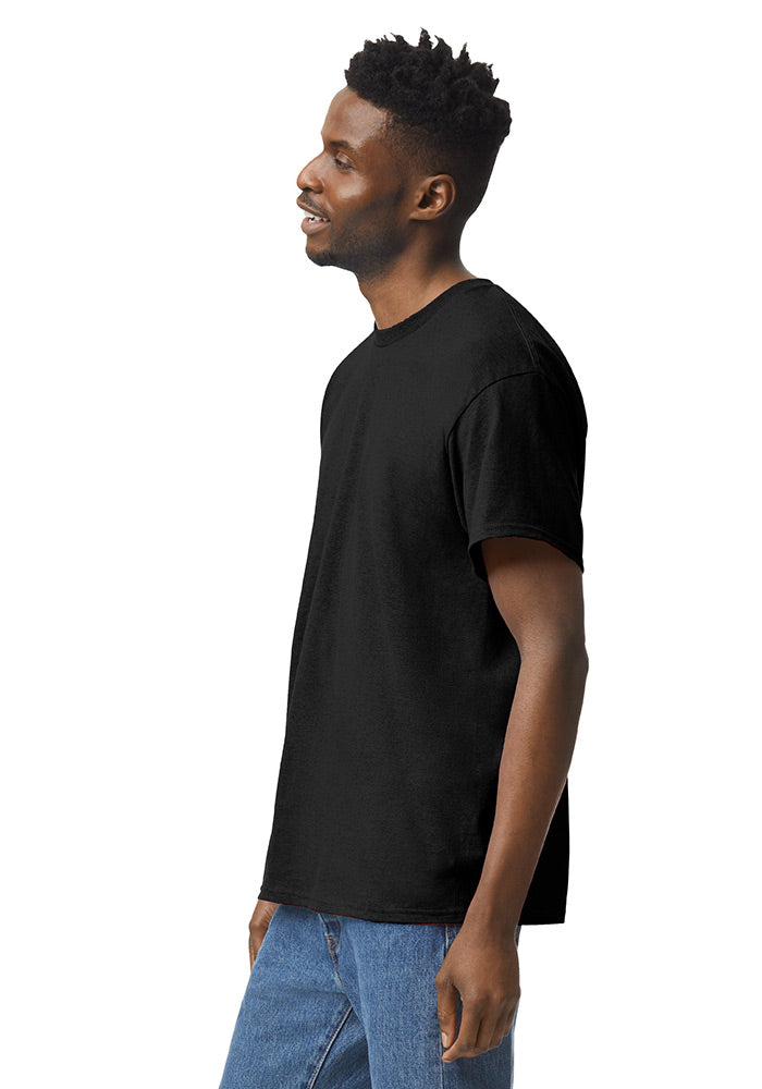 Side view of a man wearing a black Gildan 5.3oz. Cotton Short Sleeve T-shirt and blue jeans on a white background.