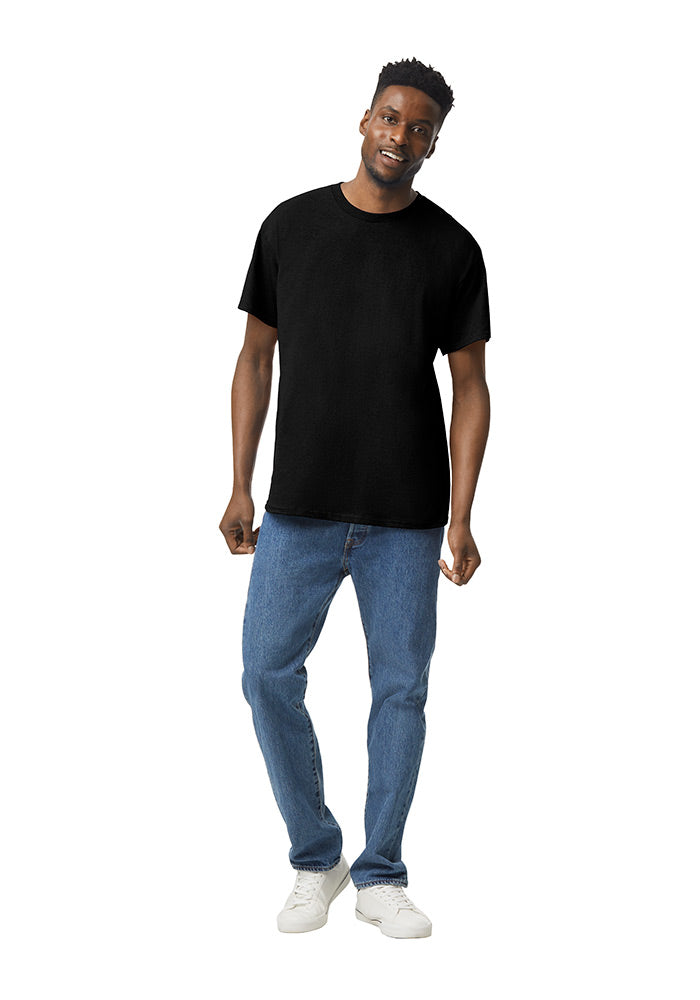 Man wearing a black Gildan 5.3oz. Cotton Short Sleeve T-shirt and blue jeans on a white background.
