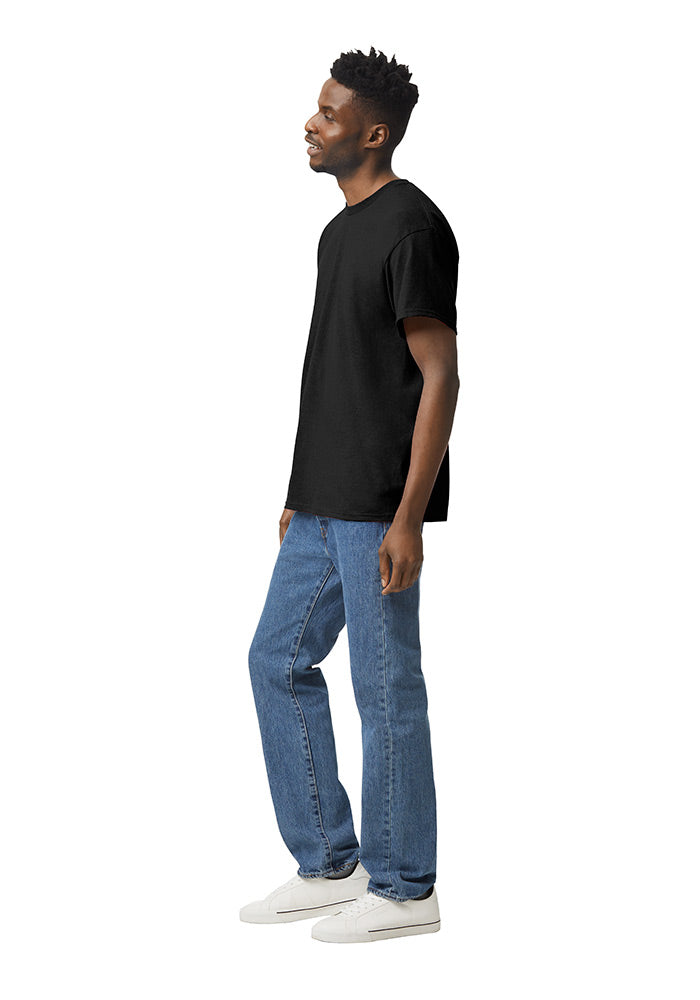 Side view of a man wearing a black Gildan 5.3oz. Cotton Short Sleeve T-shirt and blue jeans on a white background.