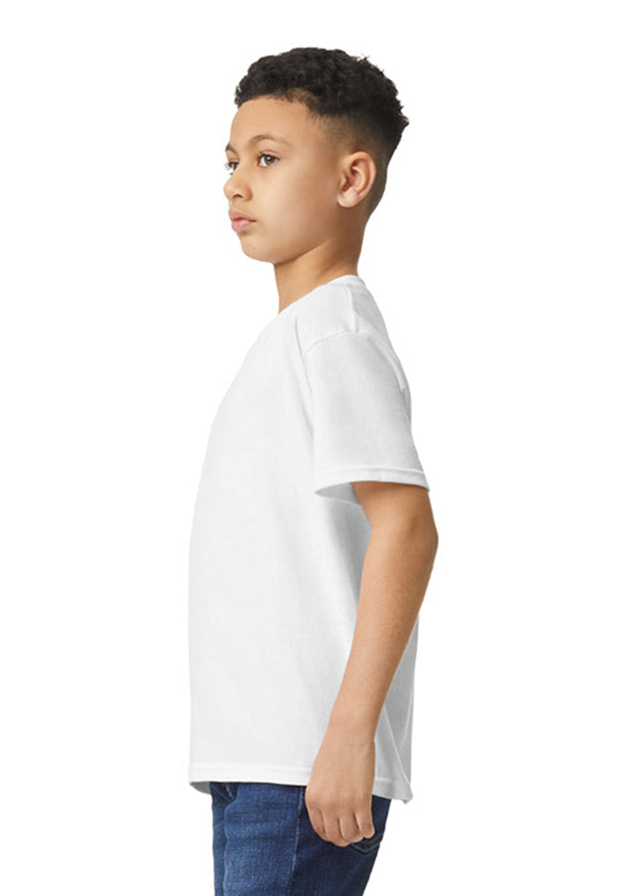 Sideview of a boy wearing a Gildan 5.3 oz. heavy cotton, short-sleeved white t-shirt on a white background.