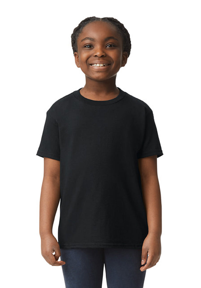 A girl wearing a Gildan 5.3 oz. heavy cotton, short-sleeved black t-shirt and blue jeans on a white background.