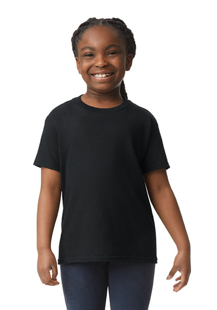 A girl wearing a Gildan 5.3 oz. heavy cotton, short-sleeved black t-shirt and blue jeans on a white background.