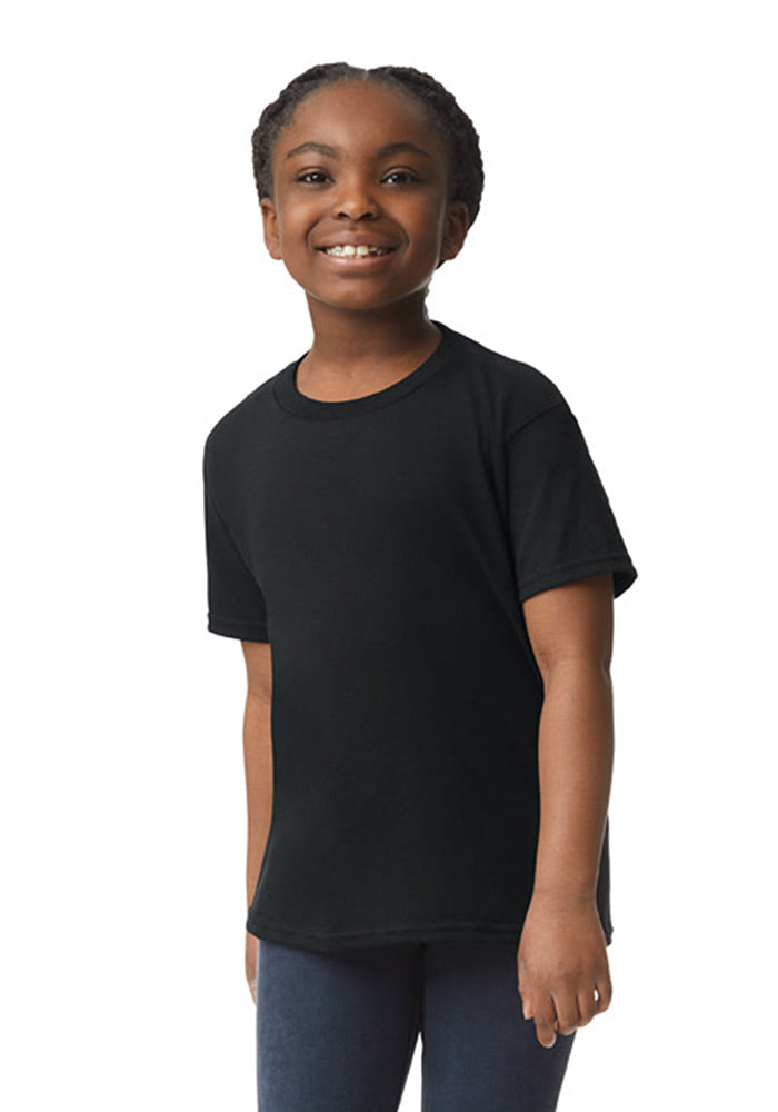 A girl wearing a Gildan 5.3 oz. heavy cotton, short-sleeved black t-shirt and blue jeans on a white background.