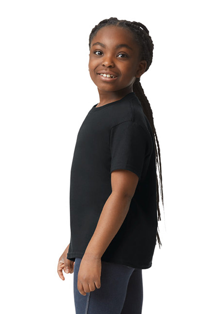 Side view of a child wearing a Gildan 5.3 oz. heavy cotton, short-sleeved black t-shirt and blue jeans on a white background.