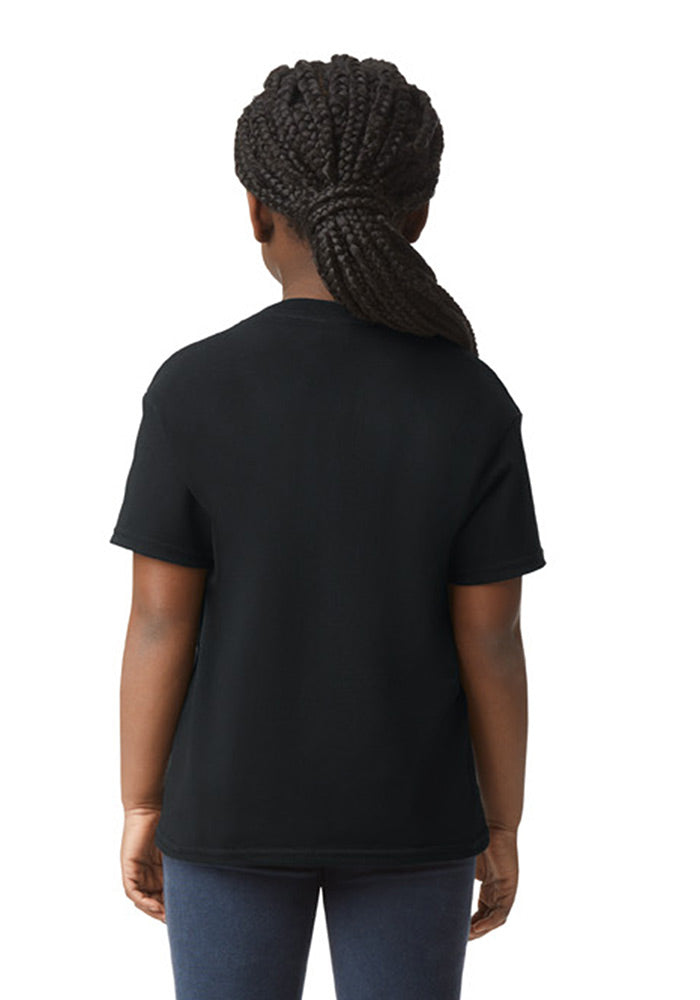 Back view of a child wearing a Gildan 5.3 oz. heavy cotton, short-sleeved black t-shirt and blue jeans on a white background.