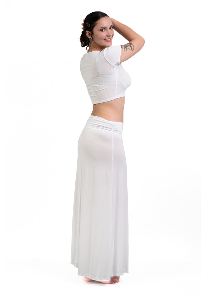 Side view of woman wearing a white rayon/spandex crop-top with short sleeves and front shirring on a white background.